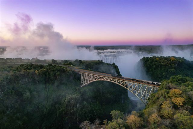 Luxury steam train dining experience on Victoria Falls Bridge with elegant interior and gourmet dinner service